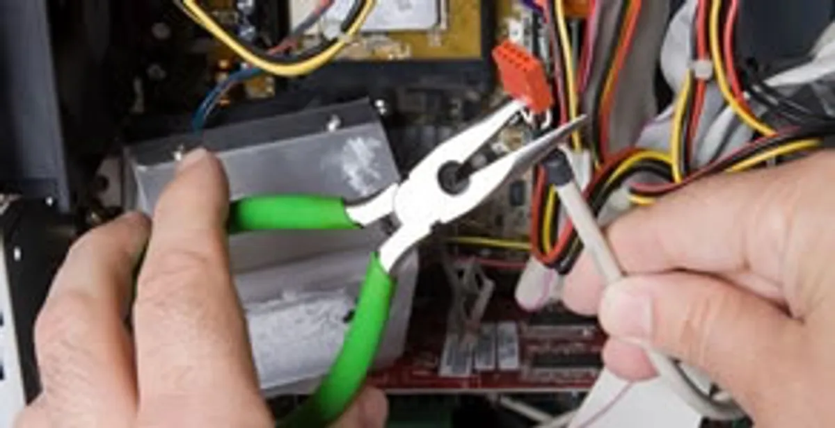 Licensed electrical contractor performing electrical repair with tools in Wake Forest, NC