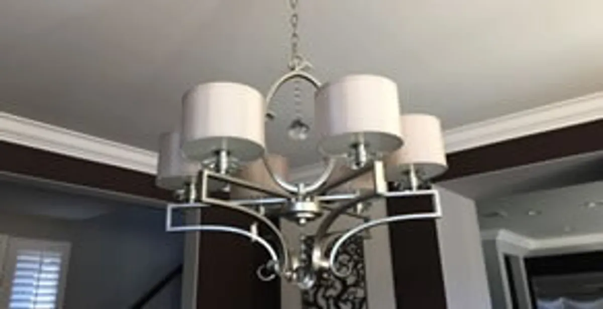 Modern chandelier installation with multiple light fixtures in Raleigh, NC
